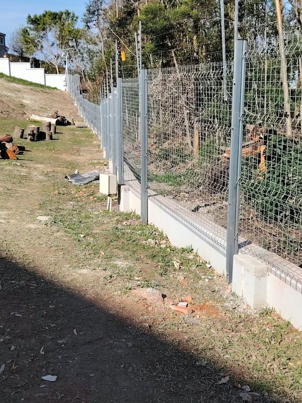 Welded mesh fence on a retaining wall — Jozelle Fencing & Projects